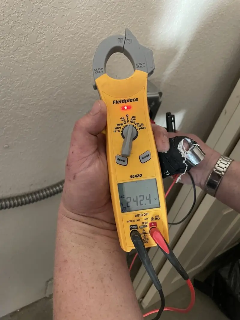 Voltage testing with clamp meter during Ceiling Fan Installation in Mount Morris